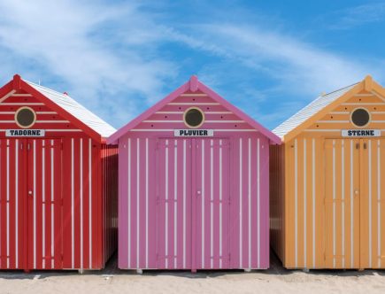 Vibrant beach huts on a sunny day in Cucq, France.