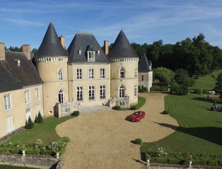 aerial view photography of red vehicle park in front of building