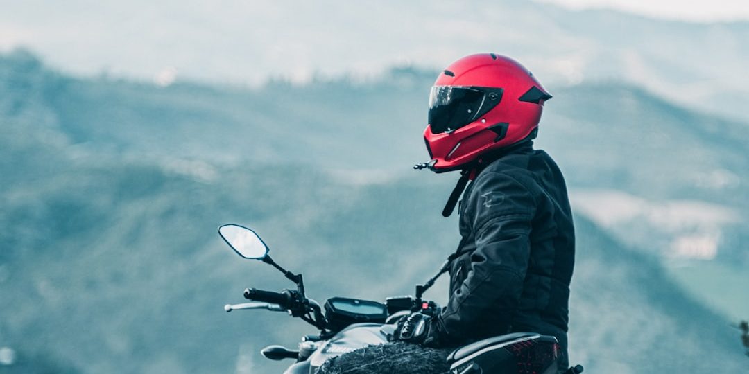 a man riding a motorcycle with a mountain in the background