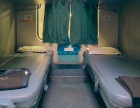 Two beds inside a train cabin.